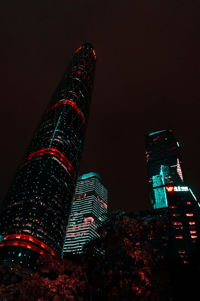 Vibrant illuminated skyscrapers in Guangzhou captured at night, showcasing modern architectural marvels in a stunning cityscape.